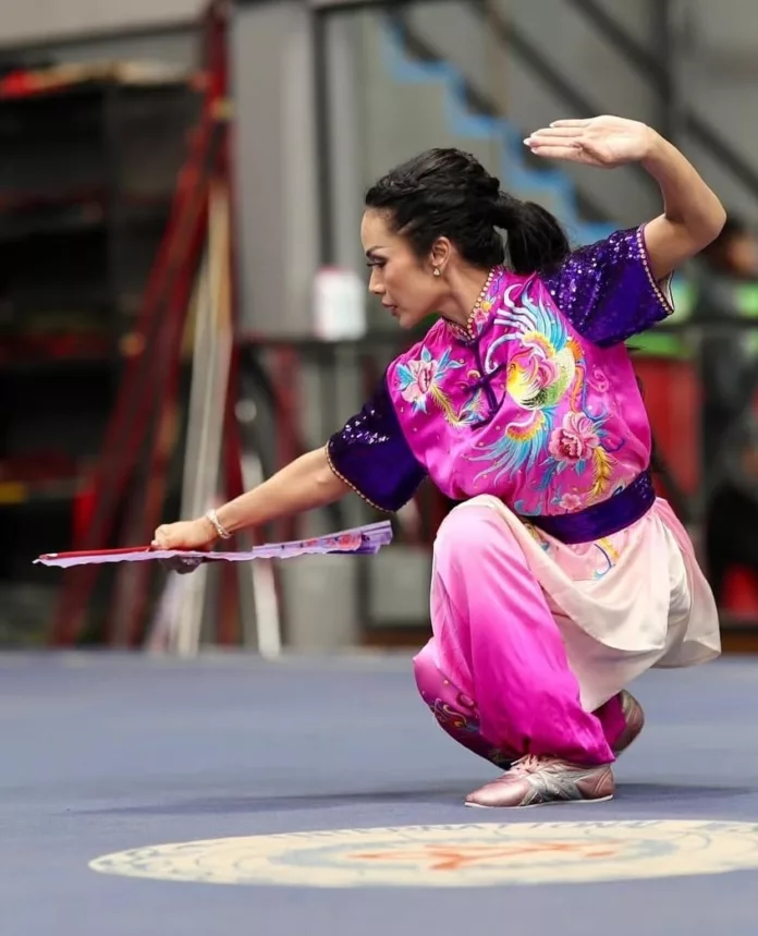 Kris Dayanti berpose dengan medali wushu yang diraihnya